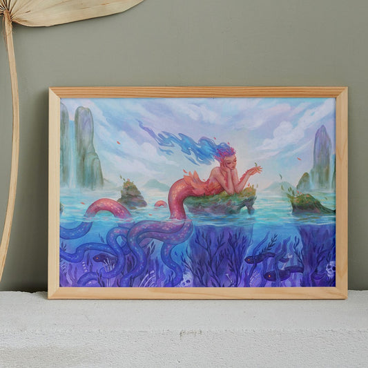 A framed painting of a beautiful mermaid with pink scales and blue flowing hair.